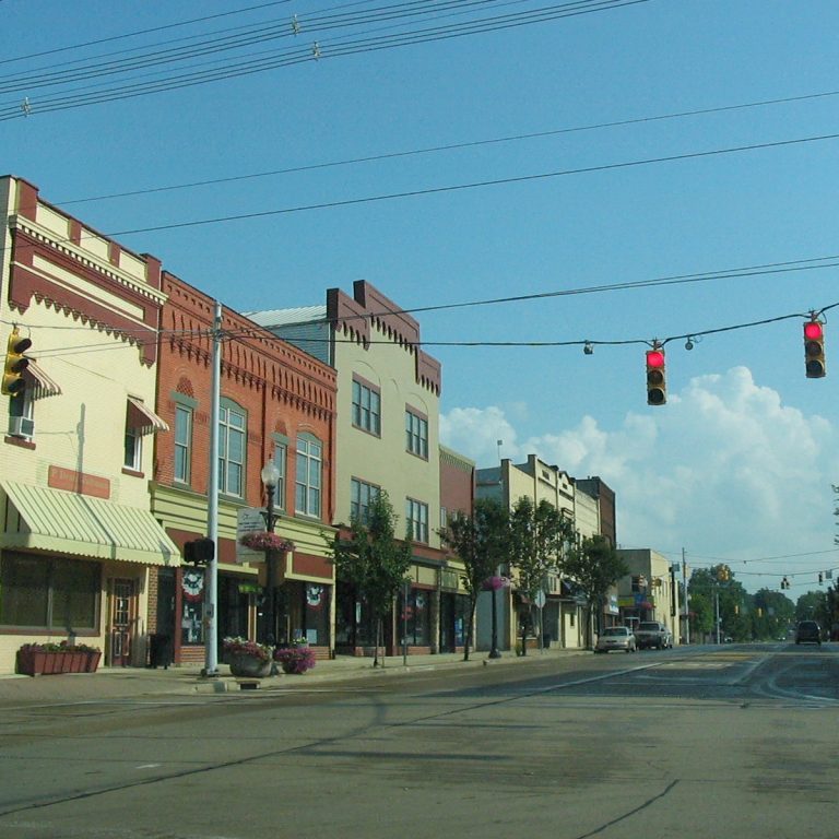 Main street in Orrville, Ohio with small businesses and nearby homes, focusing on local residential properties.